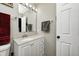 Bright bathroom featuring a single sink vanity with storage, a large mirror, and neutral wall paint at 1614 Ashley Dr, Lebanon, IN 46052