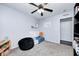 bedroom with a gray carpet, light blue walls, ceiling fan, and a white toddler bed at 1614 Ashley Dr, Lebanon, IN 46052
