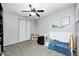 bedroom with a gray carpet, light blue walls, ceiling fan, and a white toddler bed at 1614 Ashley Dr, Lebanon, IN 46052