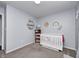 Bedroom with gray carpet, light blue walls, a crib, shelving, and a small bookshelf at 1614 Ashley Dr, Lebanon, IN 46052