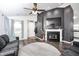 Stylish living room with fireplace, wood-look flooring, modern accents, and vaulted ceiling at 1614 Ashley Dr, Lebanon, IN 46052