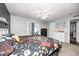 Cozy main bedroom features neutral walls, carpet floors, ceiling fan, and a door to an enclosed patio at 1614 Ashley Dr, Lebanon, IN 46052