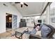 Sunroom features vaulted ceilings, ceiling fan, lots of windows, and comfortable seating on a colorful area rug at 1614 Ashley Dr, Lebanon, IN 46052