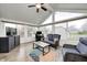 Bright sunroom with vaulted ceilings, ceiling fan, lots of windows, and comfortable seating on a colorful area rug at 1614 Ashley Dr, Lebanon, IN 46052
