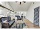 Bright sunroom with vaulted ceilings, ceiling fan, lots of windows, and comfortable seating on a colorful area rug at 1614 Ashley Dr, Lebanon, IN 46052