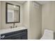 Modern bathroom featuring a vanity with dark blue cabinets and a sleek mirror at 17269 Dallington St, Westfield, IN 46074