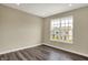 Cozy bedroom with hardwood floors and a large window overlooking the neighborhood at 17269 Dallington St, Westfield, IN 46074