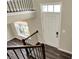 View looking down the staircase to the foyer with hardwood floors and an entry door at 17269 Dallington St, Westfield, IN 46074
