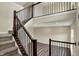 Bright foyer with hardwood floors, a staircase with dark wood railing and a view to the entry at 17269 Dallington St, Westfield, IN 46074