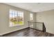 Upstairs hallway with hardwood floors, natural light, and modern light fixture at 17269 Dallington St, Westfield, IN 46074