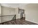 Open hallway with modern light fixture and view of the kitchen in neutral tones at 17269 Dallington St, Westfield, IN 46074