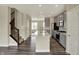 Bright kitchen features gray cabinets, stainless appliances, a large island, and wood-look floors at 17269 Dallington St, Westfield, IN 46074