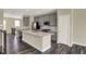 Modern kitchen with gray cabinets, stainless steel appliances, a center island, and wood-look flooring at 17269 Dallington St, Westfield, IN 46074