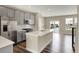 Bright kitchen with stainless steel appliances, center island, and wood flooring at 17269 Dallington St, Westfield, IN 46074