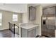 Kitchen with stainless steel refrigerator, grey cabinets and modern pendant lighting at 17269 Dallington St, Westfield, IN 46074