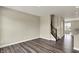 Living room with wood-look floors, adjacent to the staircase, and bright natural light at 17269 Dallington St, Westfield, IN 46074