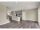 Living room featuring wood-look flooring that opens to the kitchen with a center island at 17269 Dallington St, Westfield, IN 46074