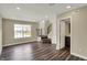 Open-concept living room with hardwood floors, neutral walls, and natural light at 17269 Dallington St, Westfield, IN 46074