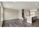 Open-concept living room and kitchen area featuring wood-look flooring and lots of natural light at 17269 Dallington St, Westfield, IN 46074