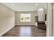 Bright living room with hardwood floors, large window, and staircase at 17269 Dallington St, Westfield, IN 46074