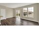 Open-concept living room features wood-look floors, multiple windows, and access to the outside deck at 17269 Dallington St, Westfield, IN 46074