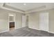Spacious main bedroom with tray ceiling, carpet floors, and bathroom entrance at 17269 Dallington St, Westfield, IN 46074