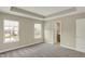 Bright main bedroom with tray ceiling, carpet floors, and two windows for natural light at 17269 Dallington St, Westfield, IN 46074