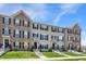Inviting townhouse exteriors with well-kept lawns, classic black shutters, and blue skies overhead at 17269 Dallington St, Westfield, IN 46074