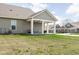 Large backyard with a covered patio and swing, perfect for relaxing outdoors at 17302 Graley Pl, Westfield, IN 46074