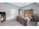 Spacious bedroom with a tray ceiling, cozy bedding, and an entertainment center at 17302 Graley Pl, Westfield, IN 46074