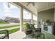 Inviting front porch with wicker furniture and decorative hanging lights at 17302 Graley Pl, Westfield, IN 46074