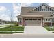 Front exterior featuring a two-car garage and well-maintained landscaping at 17302 Graley Pl, Westfield, IN 46074