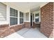 Welcoming covered porch with brick accents and ample natural light at 17302 Graley Pl, Westfield, IN 46074