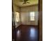 Bedroom features hardwood floors, and natural light from two windows at 1901 S F St, Elwood, IN 46036