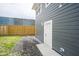 A view of the backyard featuring a newly constructed fence and an access door at 1921 Union St, Indianapolis, IN 46225