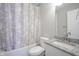 Bathroom featuring a bathtub, toilet, sink and vanity with modern fixtures and a decorative shower curtain at 1921 Union St, Indianapolis, IN 46225