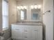 Bathroom featuring double sink vanity with granite countertops, modern fixtures, and ample storage at 1921 Union St, Indianapolis, IN 46225