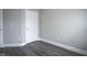 Bedroom with light gray walls, white trim, modern gray laminate flooring, and a white door at 1921 Union St, Indianapolis, IN 46225