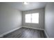 Bedroom with modern gray laminate flooring, freshly painted light gray walls, and a bright window at 1921 Union St, Indianapolis, IN 46225