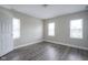 Bedroom featuring three large windows allowing for ample natural light and gray laminate flooring at 1921 Union St, Indianapolis, IN 46225
