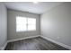Bright bedroom with modern gray laminate flooring, white trim, and a large window for natural light at 1921 Union St, Indianapolis, IN 46225