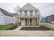 Charming two-story home featuring a welcoming front porch with wood railings and a neatly landscaped yard at 1921 Union St, Indianapolis, IN 46225