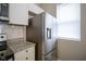 Stainless steel refrigerator with granite counters, subway tile backsplash and white cabinets at 1921 Union St, Indianapolis, IN 46225