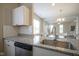 Close up of sink and countertops, plus view to eat-in kitchen area and living room beyond at 1921 Union St, Indianapolis, IN 46225