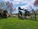 Lush green backyard with a play set and scenic views, ideal for outdoor activities at 1995 Brookfield Ct, Columbus, IN 47201