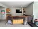 Basement area with a TV, wet bar, shelving, and exercise equipment for entertainment and fitness at 1995 Brookfield Ct, Columbus, IN 47201