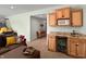 Basement wet bar with wooden cabinetry, granite countertops, and a beverage refrigerator at 1995 Brookfield Ct, Columbus, IN 47201