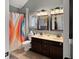 This full bath features a shower with tub, double sinks, and neutral paint at 1995 Brookfield Ct, Columbus, IN 47201