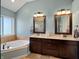 This primary bath features a separate shower and soaking tub, double sinks, and a neutral color palette at 1995 Brookfield Ct, Columbus, IN 47201