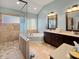 This primary bath features a separate shower and soaking tub, double sinks, and tiled floor at 1995 Brookfield Ct, Columbus, IN 47201